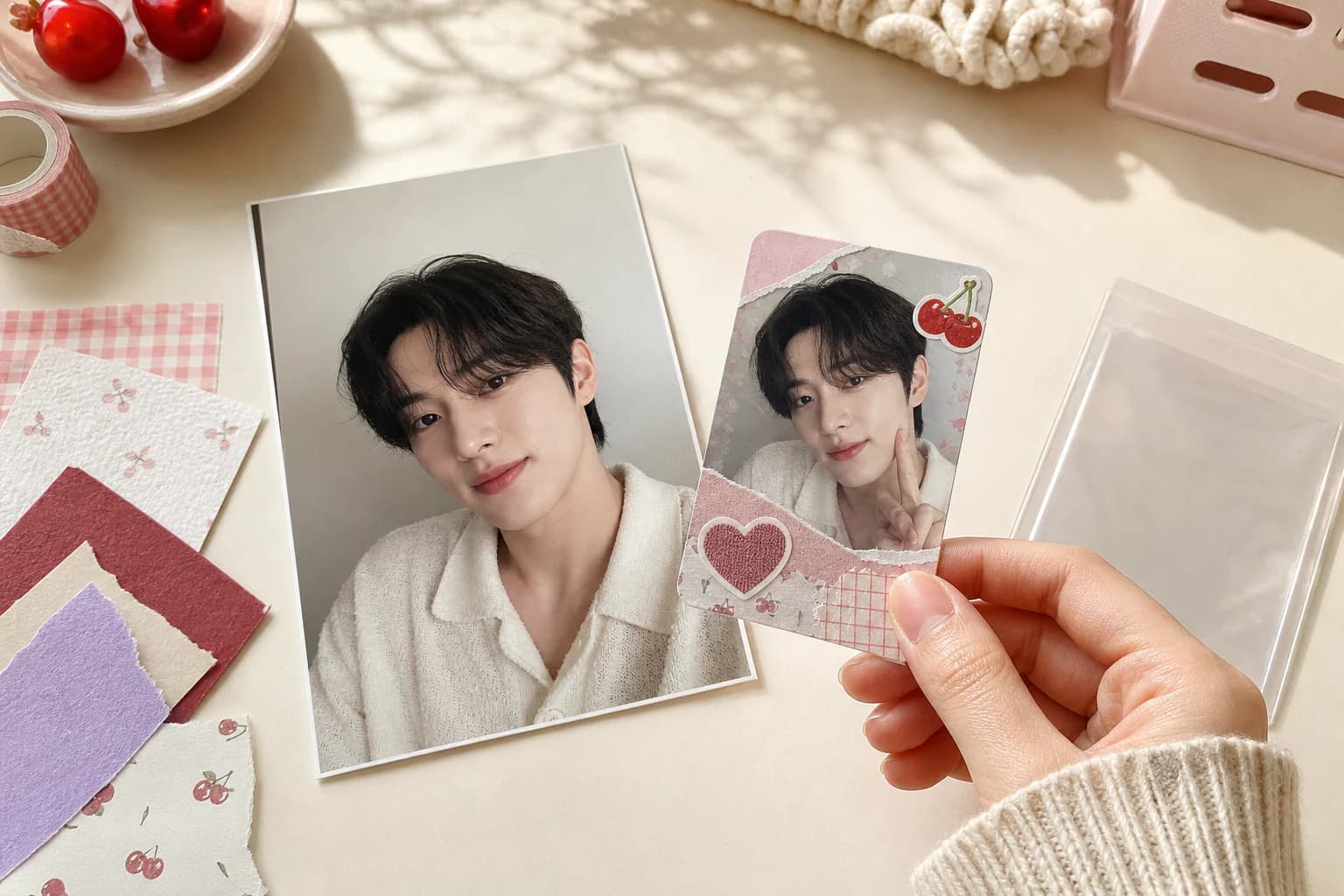 A source portrait beside a matching fan-made photocard held over a cream craft desk